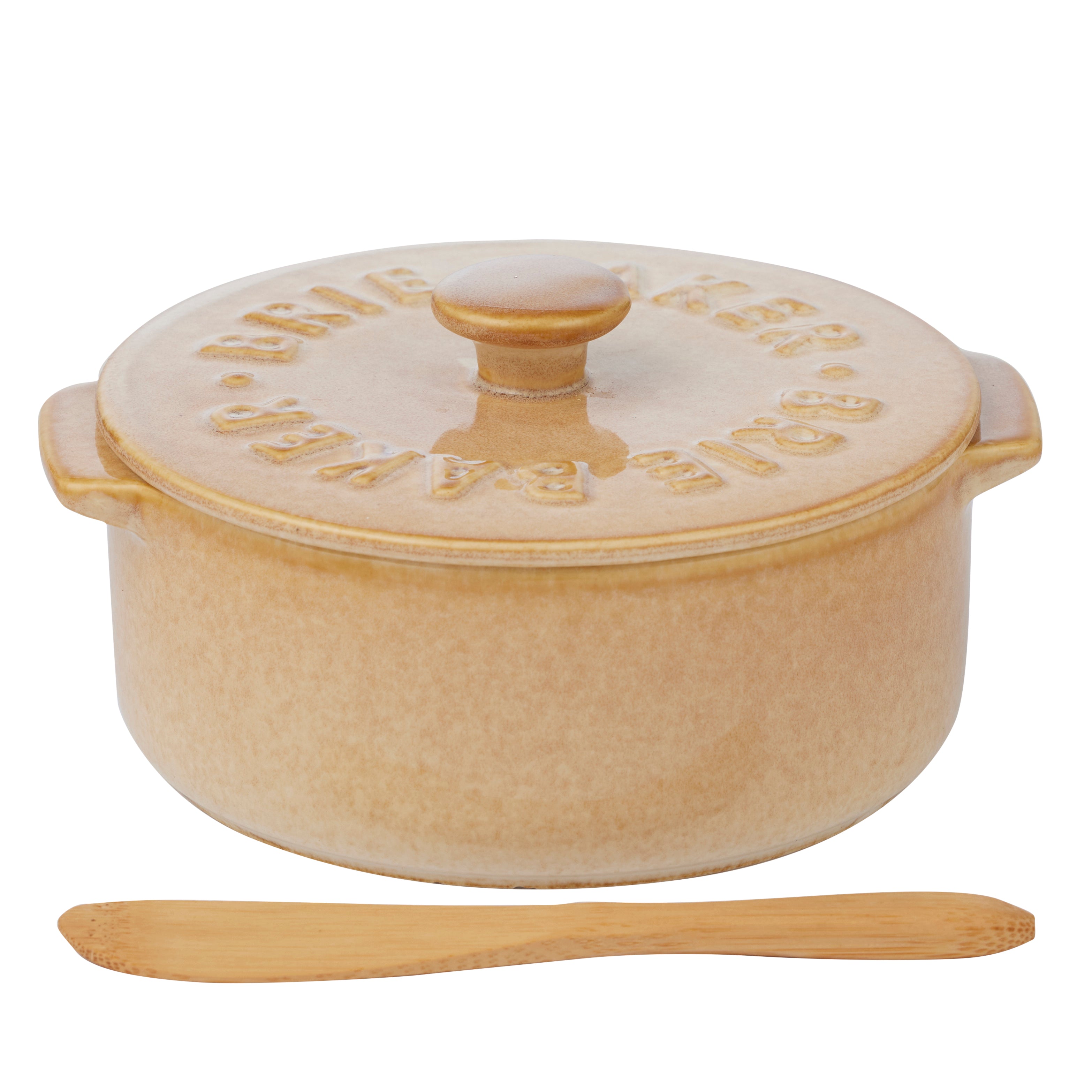 Beige ceramic baking dish with wooden knife on a white background