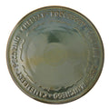 Round ceramic cheese platter with embossed text on a white background