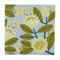 Floral patterned fabric swatch with green leaves and yellow flowers on a blue background