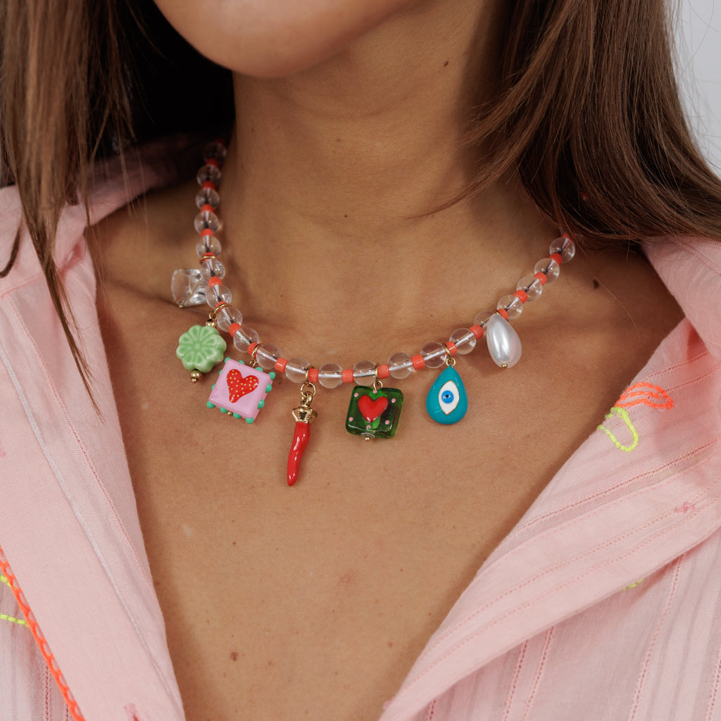zoda beaded charm necklace with clear orange beads and colourful heart chilli and evil eye charms