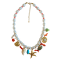 zoda pearl charm necklace with starfish shell and coral charms on white background