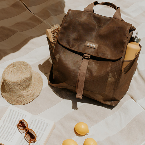 sande brown mesh drawstring beach backpack with a flap top