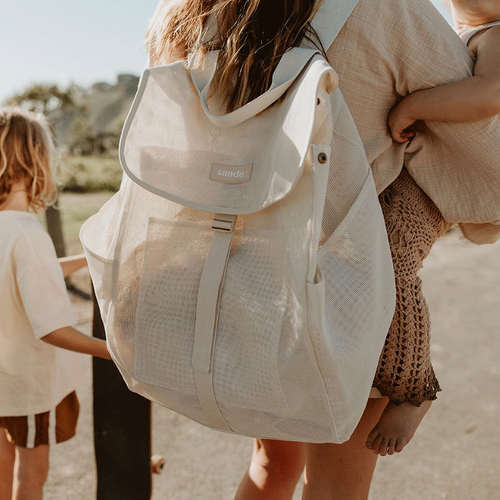 sande sand cream mesh drawstring beach backpack with a flap top