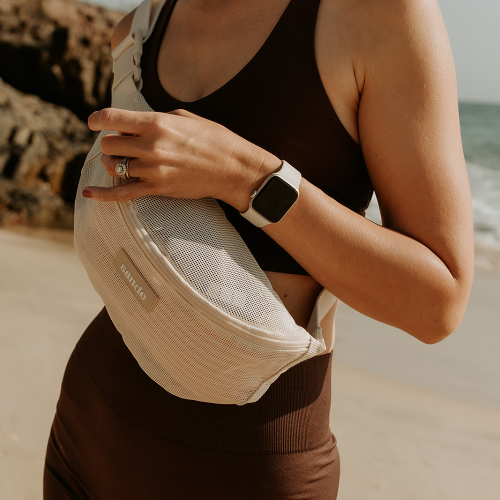 sande sand beige mesh essentials crossbody bag worn across the body at the beach